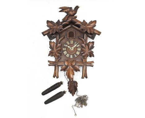 20th Century Black Forest weight carved cuckoo clock, with Roman chapter ring, the weight-driven movement operating a cuckoo 
