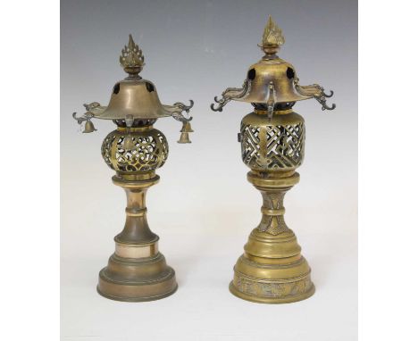 Two Far Eastern brass table lamps, each of lantern form with flaming pearl final and hooks to overhanging roof (one hung with