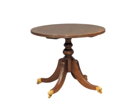An inlaid mahogany pedestal lamp table on brass lion paw feet. 61.5x51.5cm 