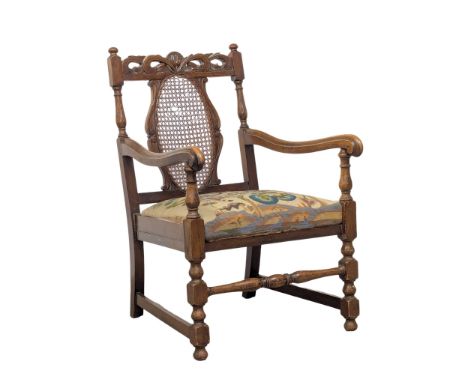 An Early 20th Century beech armchair in the 17th century style with original tapestry seat and berger back. 