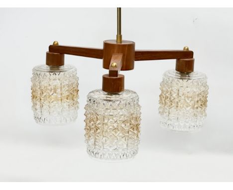 A 1960’s Mid Century teak ceiling light with glass shades. 43x42x46cm 