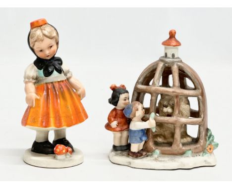 An Early Goebel Pottery Kinderland Children and Lion Cage figures. Together with a Cortendorf figurine. 