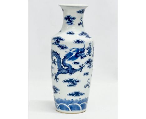 A Late 19th Century Chinese vase. With two blue dragons, clouds and pearl of wisdom. Kangxi 4 character mark. 27cm 