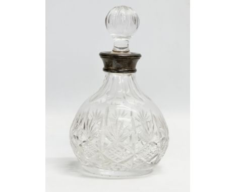 Silver mounted decanter. A Late 20th Century silver mounted crystal decanter by Lawrence R. Watson. 1988. 19.5cm 