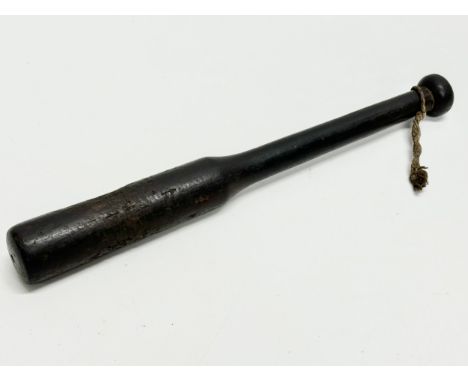 A 19th Century ebony police truncheon. 28cm 