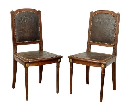 A pair of good quality late 19th French Directoire style mahogany side chairs, with patch leather back and seats. Circa 1890.