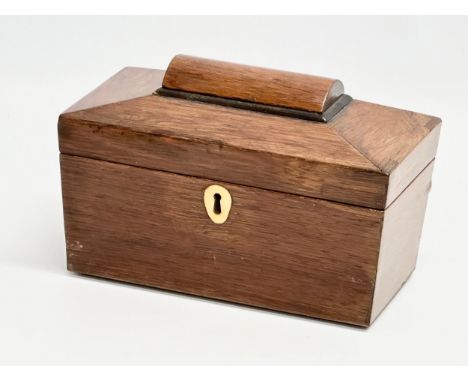 A Regency rosewood sarcophagus tea caddy with nickel silver spoon. Circa 1810. 23x12x14cm 