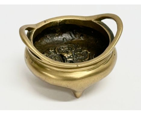 An 18th/19th Century Chinese brass tripod censer with impressed interior dragon motif. Impressed Emperor Xuande seal mark. 8x