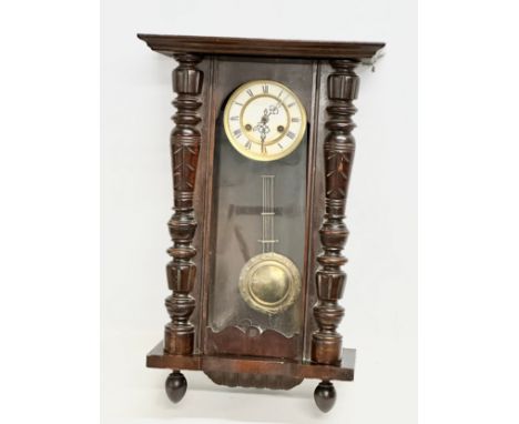 A Late 19th Century Victorian mahogany Vienna wall clock. With key and pendulum. 42x64cm 