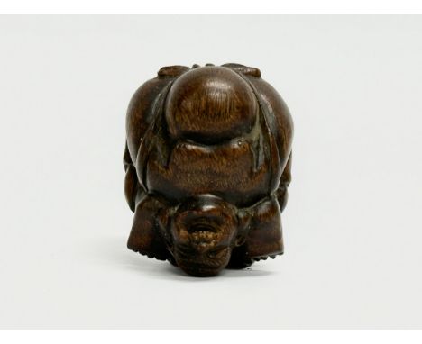 A signed Late 19th/Early 20th Century Netsuke carved wooden Buddha. 
