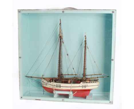 Scratch built model of a two-masted schooner, the red and white painted wooden body numbered GC-3-893, contained within woode