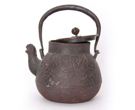 Chinese cast iron teapot, of bulbous form with ring handle, zoomorphic spout and low relief stylised decoration to body, not 