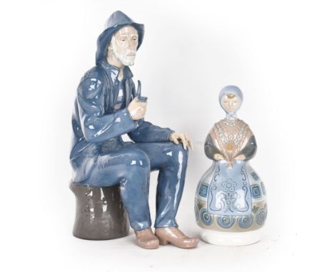 Lladro figure, Girl in Traditional Dress no 1159, together with Nao figure Old Fisherman Smoking a Pipe