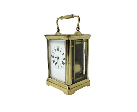 20th century -  8-day striking carriage clock in a corniche case, with an enamel dial , Roman numerals, minute track and stee