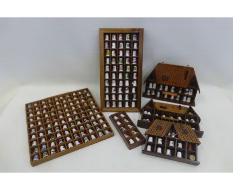 An extensive collection of ceramic/porcelain thimbles contained in six display cases, including advertising, in excess of 200