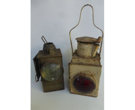 A handheld railway lamp and one other.