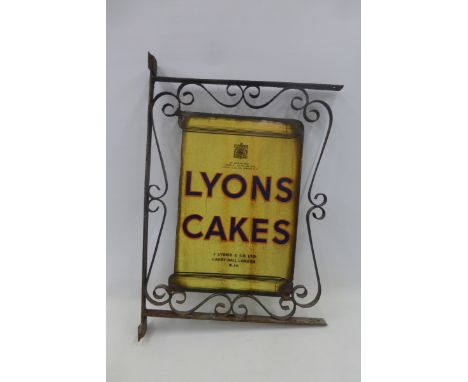 A Lyons Cakes double sided enamel sign set within a wrought iron frame, 22 1/2 x 32 3/4" overall.
