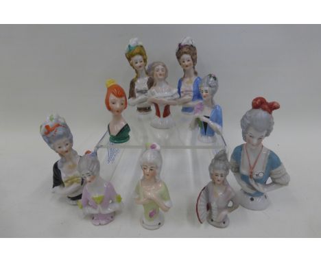 A collection of ten assorted ceramic pin cushion dolls including one Art Nouveau.