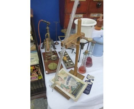 A collection of pharmaceutical equipment including scales, a miniature sink etc.