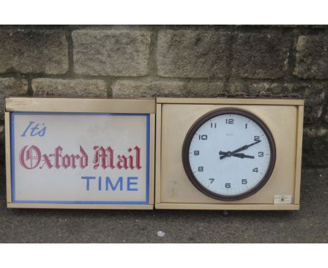A rectangular two section wall clock/light box "It's Oxford Mail Time" with a Smiths bakelite circular clock, property of Nor