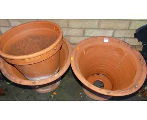A pair of terracotta cylindrical tapering planters, together with a further single planter (3)