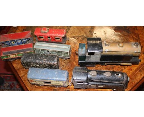 One tray containing a collection of mixed O gauge trains and accessories to include  a Bowman live steam 0-4-0  tank loco