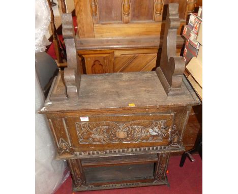 An early 20th century relief carved oak hanging wall shelf, width 63cm