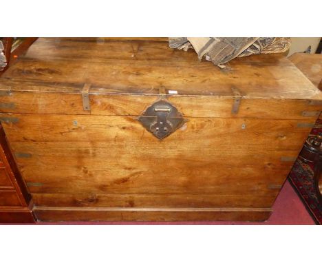 A large camphor wood and brass bound hinge top trunk, having brass end carry handles, width 130cm