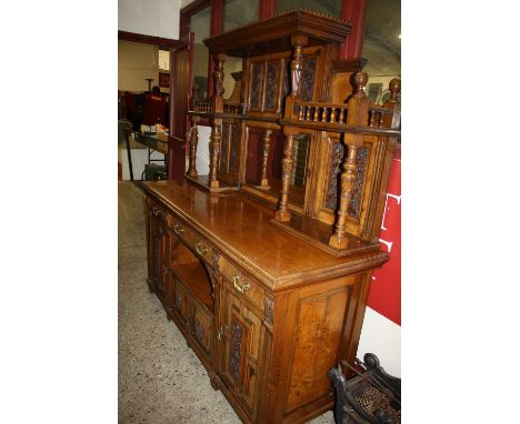 A late Victorian heavily relief carved oak mirror back sideboard, the raised superstructure with bevelled mirror plate, surro