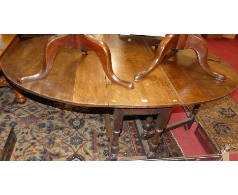 A joined oak D-end drop leaf dining table, having a gate leg action, max length 173cm