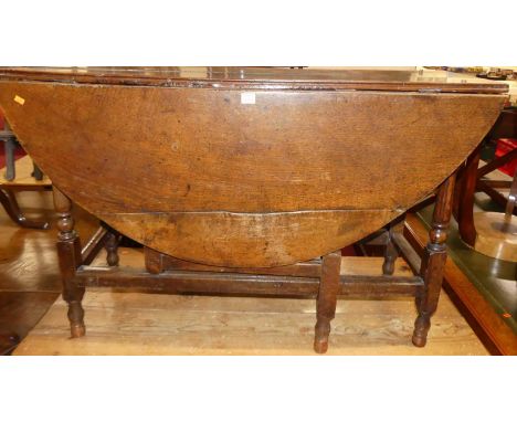 An 18th century joined oak drop leaf gate leg dining table, width 125cm