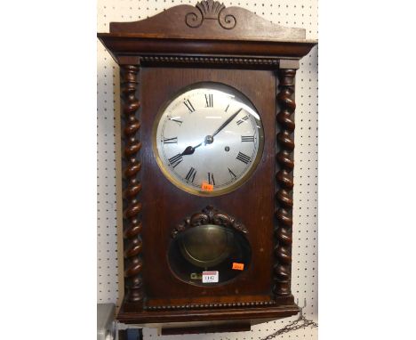 An early 20th century oak drop trunk wall clock, with two winding holes for an eight day movement with pendulum, height 65cm