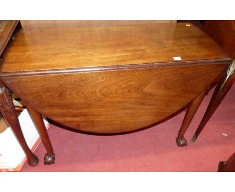 A George III mahogany demi-lune drop leaf pad foot dining table, having a gate leg action