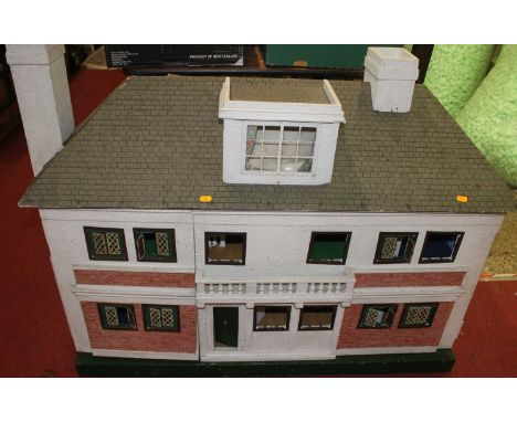 A wooden mid-20th century dolls house, fitted with electrical lighting and quantity of furniture 