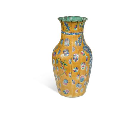 A Chinese porcelain vase, Qing Dynasty, circa 1880,incised and painted with scattered mon and Buddhist emblems in Japanese st