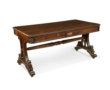 George IV rosewood library table,with gadrooned edge above two frieze drawers, on scroll end supports with foliate carved fee