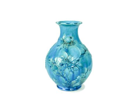 A Chinese turquoise glazed porcelain vase, Qing Dynasty, 19th century,applied and carved in high relief with a fruiting pomeg