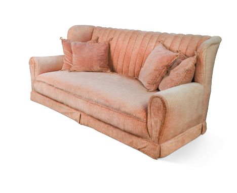 A pink upholstered three seater sofa, 20th century,with four cushions, raised on upholstered block feet 93 x 220 x 90cmProven