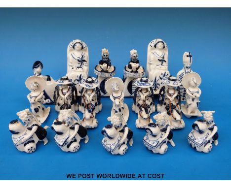 Eighteen Wilfred Gibson blue and white ceramic figures including rocking horses, Craftsman Potter, priest etc