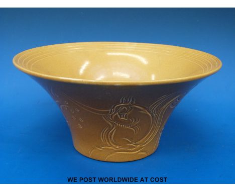A Susie Cooper bowl with sgraffito decoration of squirrels on a mustard ground 