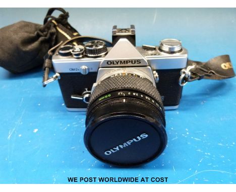 An Olympus OM-2N SLR camera fitted with a 55mm 1:1.2 Zuiko lens and a 1:2.8 f=28mm lens