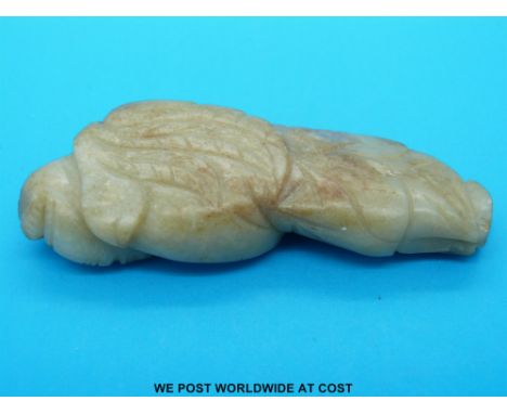 A Chinese jade figure of a sage with russet inclusions (8cm long) 