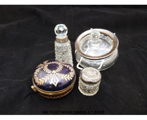 An enamelled brass mounted hinged trinket dish, silver mounted bottles and an unmarked example. 