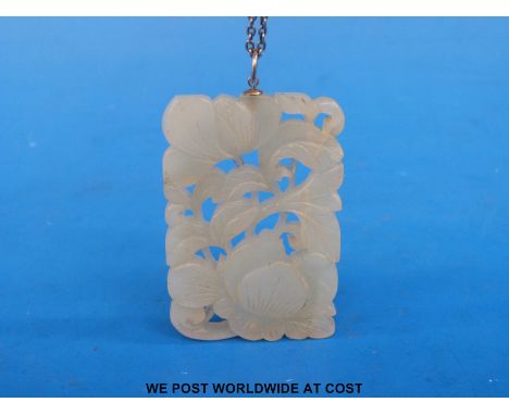 A white jade nephrite pendant carved with floral decoration