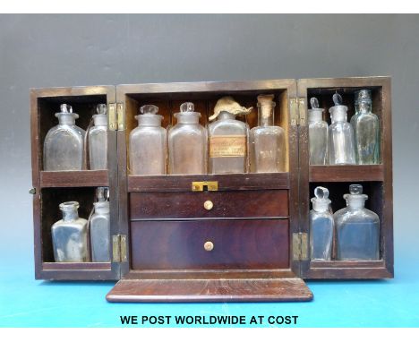 A Georgian mahogany medicine cabinet with two pull out drawers, probably by Shringweiler & Co. London with contents of assort