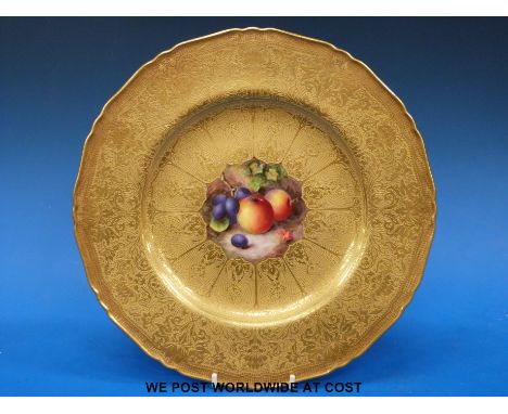 A Royal Worcester hand painted fruit gilded cabinet plate, the central panel painted with grapes and peaches and signed W.Bee