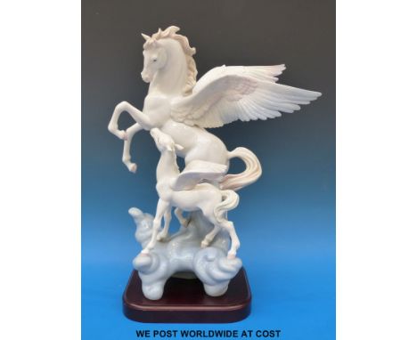 A large Lladro figure of Pegasus and foal on wooden base. 