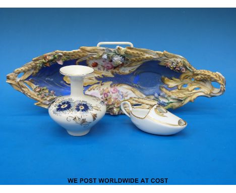 A 19thC porcelain flower encrusted boat-shaped pierced dish and a Zsolnay Pecs vase