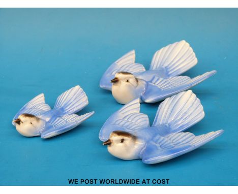 Three Poole pottery graduated bluebird wall plaques 