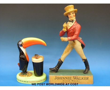 A Carltonware Guinness toucan lamp and a Johnnie Walker figure